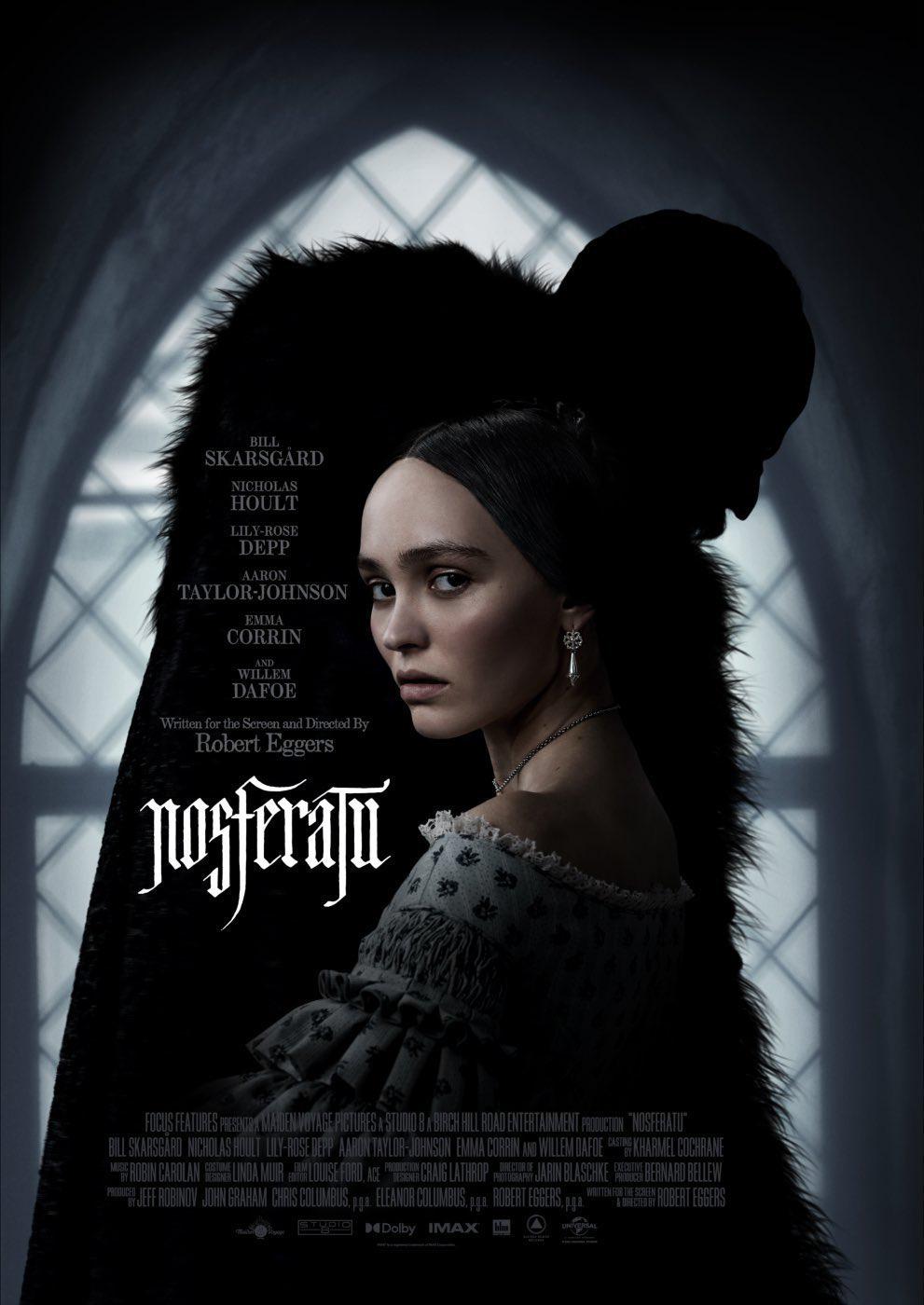 A dark and eerie movie poster for the 2024 film ‘Nosferatu,’ directed by Robert Eggers. The foreground features a pale young woman with dark hair (played by Lily-Rose Depp) wearing a historical-style dress with lace trim, looking over her shoulder with a concerned expression. Behind her, an ominous shadowy figure with an elongated head and hunched posture looms, its silhouette resembling the iconic Nosferatu vampire. The gothic setting includes a large arched window in the background, casting dim light into the room. The film’s title, ‘Nosferatu,’ appears in a stylized, horror-themed font, along with the names of the main cast, including Bill Skarsgård, Nicholas Hoult, Aaron Taylor-Johnson, Emma Corrin, and Willem Dafoe.